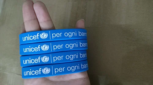 Close-up comparison of different logo imprint methods on silicone wristbands